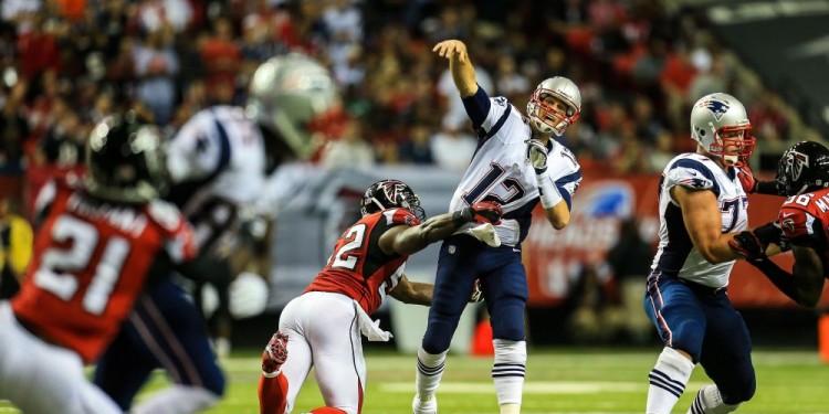 Sep 29, 2013; Atlanta, GA, USA; New England Patriots quarterback Tom Brady (12) throws while being hit by Atlanta Falcons linebacker Akeem Dent (52) in the first half at the Georgia Dome. Mandatory Credit: Daniel Shirey-USA TODAY Sports