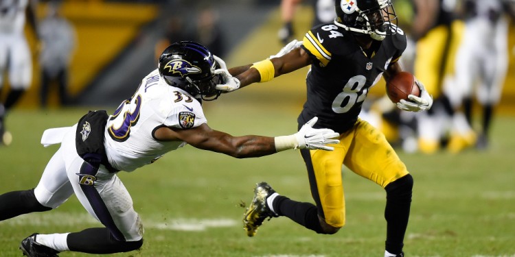 PITTSBURGH, PA - NOVEMBER 02:  Antonio Brown #84 of the Pittsburgh Steelers breaks a tackle by Will Hill #33 of the Baltimore Ravens and scores a 54 yard touchdown during the fourth quarter at Heinz Field on November 2, 2014 in Pittsburgh, Pennsylvania.  (Photo by Joe Sargent/Getty Images)